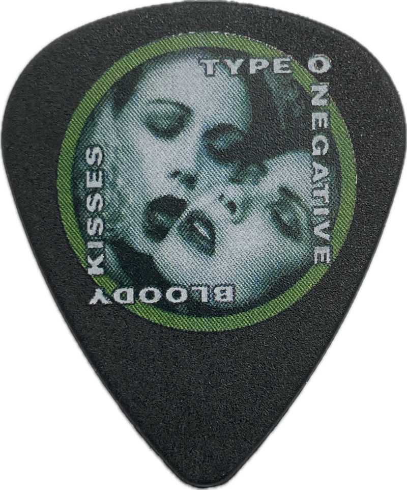 Front of a black Type O Negative Bloody Kisses guitar pick with a green circular border and skull artwork Front of a black Type O Negative Bloody Kisses guitar pick with a green circular border and skull artwork