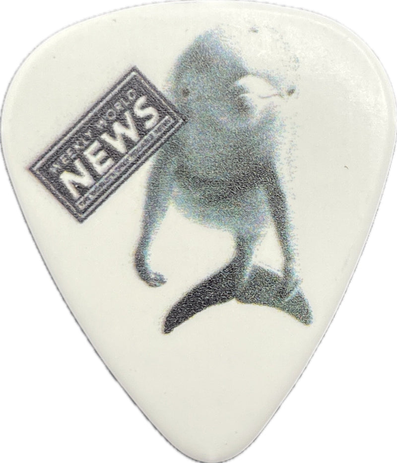 Weekly World News dolphin artwork on a white guitar pick Weekly World News dolphin artwork on a white guitar pick