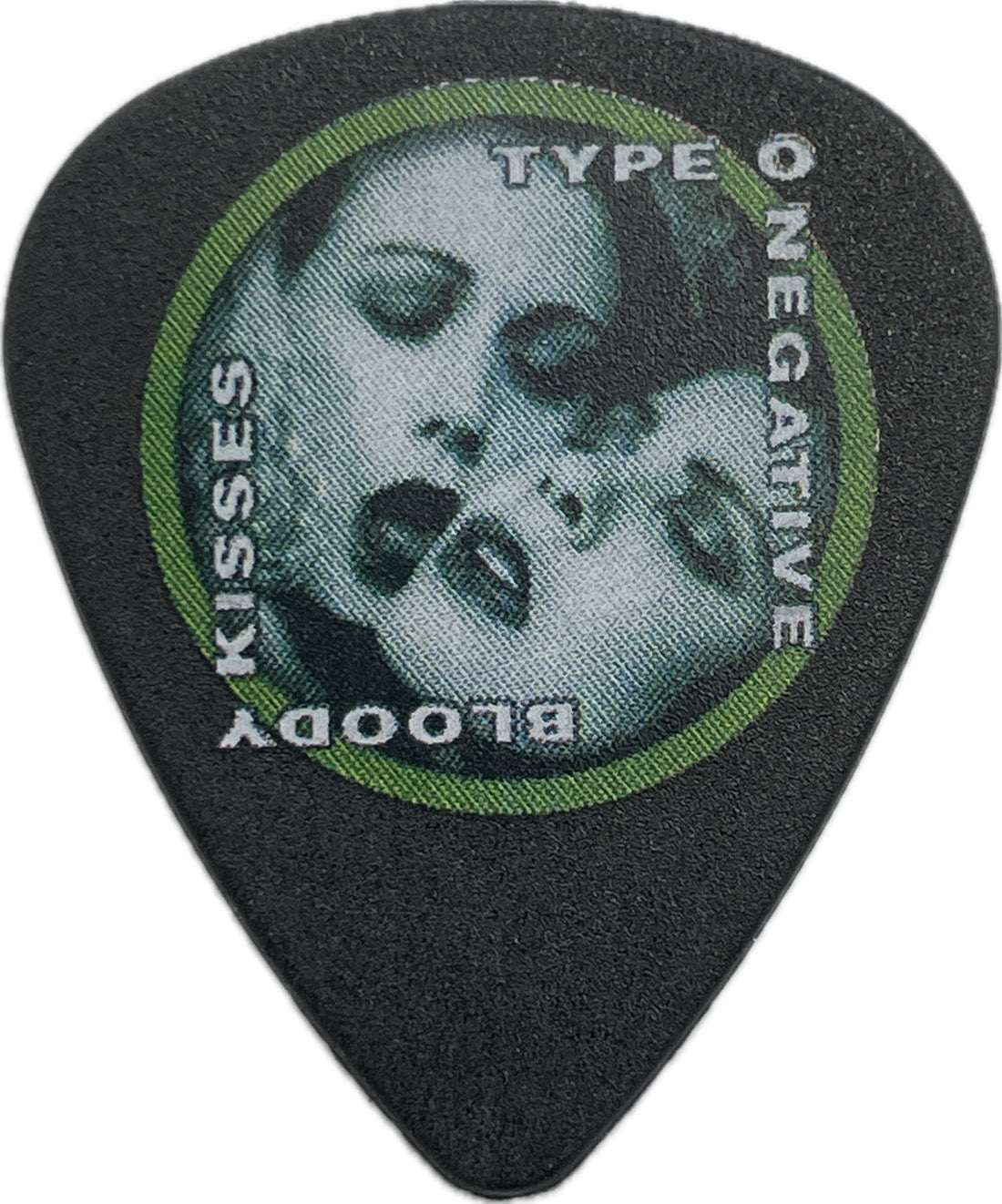 Front of a black Type O Negative Bloody Kisses guitar pick with a green circular border and skull artwork