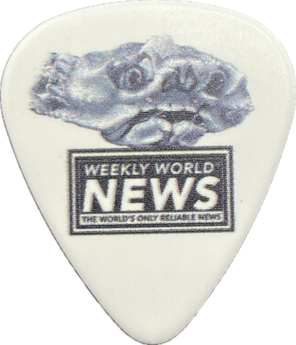 Weekly World News crab artwork on a white guitar pick